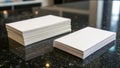 Stacks of white paper are neatly arranged on a polished black granite countertop. Royalty Free Stock Photo