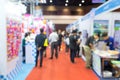 Blurred Exhibition Hall with Attendees and Booths Royalty Free Stock Photo