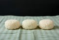 Three round rice cakes arranged neatly on striped green cloth Royalty Free Stock Photo