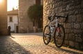 A road bike leans against a stone wall in a sunlit cobblestone street. Sunlight casts warm tones generative ai Royalty Free Stock Photo