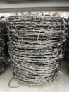 Malaysia November 2 2025 Neatly Stacked Barbed Wire Rolls on Metal Storage Rack Royalty Free Stock Photo