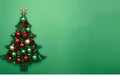 Festive Christmas tree decorated with colorful ornaments on green background Royalty Free Stock Photo