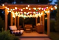Cozy outdoor patio decorated with colorful string lights evening ambiance Royalty Free Stock Photo