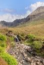 Fairy Pools on Skye, a stream meanders through stones under Cuillin mountain shadows Royalty Free Stock Photo