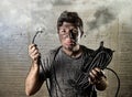 Untrained man cable suffering electrical accident with dirty burnt face in funny shock expression Royalty Free Stock Photo