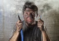 Untrained man joining electrical cable suffering electrical accident with dirty burnt face in funny shock expression Royalty Free Stock Photo