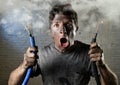 Untrained man joining electrical cable suffering electrical accident with dirty burnt face in funny shock expression Royalty Free Stock Photo