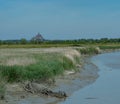 Marshland and a river in front of Mont-Saint-Michel, Bretagne, France Royalty Free Stock Photo