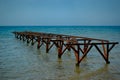 Unused iron, rusty bridge in the afternoon on the diagonal is included in the turquoise sea
