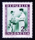Unused postage stamp Republic Indonesia 1949, President Soekarno decorates a soldier