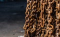 Unused and rusty snow chains hanging from a wall Royalty Free Stock Photo