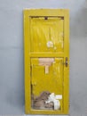 unused yellow door, leaning against the wall