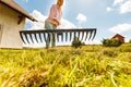 Unusual angle of woman raking leaves