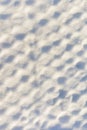 An unusual background, a grid covered with a thick layer of snow. The texture of the snow.