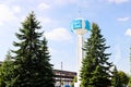 Unusual clock on a background of a white-blue sky. A clock in the form of a molecule, an atom. chemical production, a watch-column