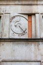 Unusual clock on stone wall in Warsaw