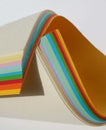 unusual composition of colored paper, bright colors on a white background, multi colored paper