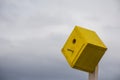 Yellow Birdhouse With Cloudy Sky Background