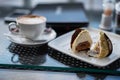 unusual dessert close-up, beautiful servingA white square plate with an unusual truffle cake, a beautiful dessert