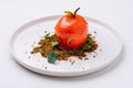 unusual dessert in the shape of a tomato on a white plate