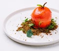 unusual dessert in the shape of a tomato on a white