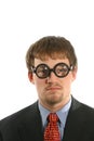 Unusual expression on man with thick glasses in business suit