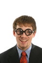 Unusual expression with smile on man with thick glasses in business suit