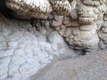 Unusual formation at the base of a rock cliff.