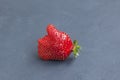 Unusual fresh organic strawberries. Like symbol Thumb up. Red juicy berry on a blue background, copy space. Concept - Eating