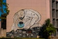 Unusual graffiti on the house, drawing on the wall: The man leaned over with the bitten globe in his hand. Havana. Cuba