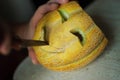 Unusual Halloween melon, cutting process, knife and male hands