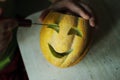 Unusual Halloween melon, cutting process, knife and male hands