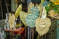 Unusual handmade clay fairy and Greenman garden stakes on display in the springtime Royalty Free Stock Photo