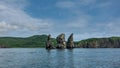 Unusual high rocks rise above the water of the Pacific Ocean.