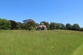 Unusual historic sixteen sided house set in acres of grassland on a beautiful sunny summers day in Devon, England Royalty Free Stock Photo