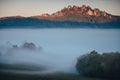 Unusual magic autumn landscape. Mist on the meadow and Royalty Free Stock Photo