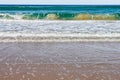 Unusual marbled looking wave coming into shore with splotches of brownish muddy water and dark green with foam - Noosa Heads