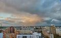 Unusual multicolored clouds over the city during sunset. Clouds over high-rise residential buildings in a residential area of the Royalty Free Stock Photo