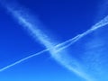 Unusual plane tracks in the blue autumn Swiss sky or conspiracy theory - chemtrails in our heaven, Davos - Canton of Grisons