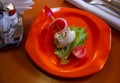 Unusual presentation of olivier salad in children style in shape of boat