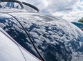 Unusual reflections, classic car and sky