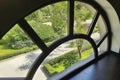 Unusual rounded window in the interior. The concept of a modern interior