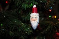 Unusual Santa Ornament with Face Painted on a Light Bulb on a Christmas Tree Royalty Free Stock Photo