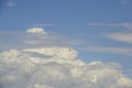 Unusual sky - billowing white clouds in blue teal sky with horizontal grey whispy almost transparent clouds in foreground