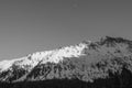 Unusual straight mountain with a snow-capped peak