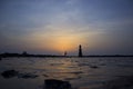 Unusual sunset observed at Mumbai India. Silhouette of a person kicking sun nearby a couple at bandra Bandstand.