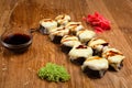 Unusual sushi rolls on a wooden table. Ukrainian sushi rolls with baked cheese and crabs