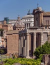 An unusual view of the Roman forum under clear blue sky.