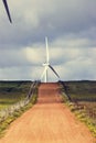 Wind Turbine and Red Dirt Road Royalty Free Stock Photo