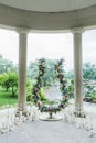 Unusual wedding arch with fresh flowers